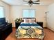 Cozy bedroom featuring a decorative bedspread, ceiling fan, and two matching night stands at 8973 Sw 104Th Pl, Ocala, FL 34481