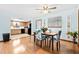 Dining room with wood floors, a modern light fixture, and a clear view of the adjacent kitchen at 8973 Sw 104Th Pl, Ocala, FL 34481