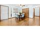 Dining room with wood floors, a modern light fixture, and an adjacent storage closet at 8973 Sw 104Th Pl, Ocala, FL 34481