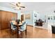 Dining room with wood floors, a modern light fixture, and easy access to the living room at 8973 Sw 104Th Pl, Ocala, FL 34481