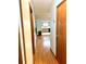 Hallway with wood-look flooring leads to a kitchen with wood cabinets and light countertops and a dining area at 8973 Sw 104Th Pl, Ocala, FL 34481