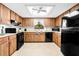 Traditional kitchen featuring wood cabinets, a black appliance package, and a window over the sink at 8973 Sw 104Th Pl, Ocala, FL 34481