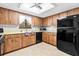 Traditional kitchen featuring wood cabinets, a black appliance package, and a window over the sink at 8973 Sw 104Th Pl, Ocala, FL 34481