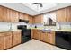 Traditional kitchen featuring wood cabinets, a black appliance package, and a window over the sink at 8973 Sw 104Th Pl, Ocala, FL 34481