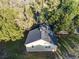 Aerial shot of a charming house with dark shingle roof surrounded by lush trees at 903 Ne 2Nd St, Ocala, FL 34470