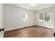 Bright bedroom with two windows and wood-look flooring at 903 Ne 2Nd St, Ocala, FL 34470