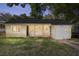 Charming yellow home featuring a welcoming front porch, well-kept lawn, and an attached garage at 903 Ne 2Nd St, Ocala, FL 34470