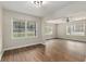 Expansive living space features wood floors, natural light and flows into the adjacent room at 903 Ne 2Nd St, Ocala, FL 34470