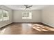 Inviting living room with wood floors, crown molding, and plenty of sunlight streaming through the windows at 903 Ne 2Nd St, Ocala, FL 34470