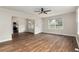 Open-concept living room showcasing wood floors, neutral walls, and a seamless transition into the adjacent spaces at 903 Ne 2Nd St, Ocala, FL 34470