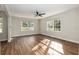 Spacious living room filled with sunlight, featuring wood floors and large windows offering a pleasant view at 903 Ne 2Nd St, Ocala, FL 34470