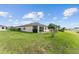 Well-maintained backyard showcases a screened-in patio, verdant lawn, and tranquil views of the surrounding landscape at 9238 Sw 60Th Terrace Rd, Ocala, FL 34476