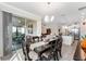 Dining area with modern furniture, leading to a covered lanai and open-concept living space at 9238 Sw 60Th Terrace Rd, Ocala, FL 34476