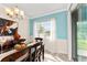 Dining area with modern furniture, chandelier, and a view of the water at 9238 Sw 60Th Terrace Rd, Ocala, FL 34476