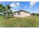 Exterior view of the home showcasing a well-kept lawn, and a glimpse of the screened-in patio, and home's architecture at 9238 Sw 60Th Terrace Rd, Ocala, FL 34476