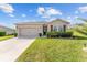 Inviting home featuring a well-kept lawn, mature landscaping, a two-car garage, and lovely curb appeal at 9238 Sw 60Th Terrace Rd, Ocala, FL 34476