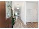 Bright hallway with wood-look flooring, white walls, and decorative accents leading into the home at 9238 Sw 60Th Terrace Rd, Ocala, FL 34476