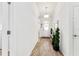 Hallway with hard surface flooring, crisp white trim and walls, and entry door with decorative glass at 9238 Sw 60Th Terrace Rd, Ocala, FL 34476