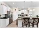 White kitchen with stainless steel appliances, an island with seating, and modern lighting fixtures at 9238 Sw 60Th Terrace Rd, Ocala, FL 34476