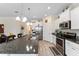 Spacious kitchen island featuring a granite countertop, sink, stainless steel appliances and breakfast bar at 9238 Sw 60Th Terrace Rd, Ocala, FL 34476