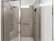 Shower stall with tiled walls, glass door, and shower head with seat at 9238 Sw 60Th Terrace Rd, Ocala, FL 34476