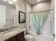 Well-maintained bathroom featuring a granite countertop, single sink, and bathtub with shower at 9480 Sw 76Th St, Ocala, FL 34481