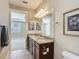 Elegant bathroom featuring granite countertop, double sinks, tiled flooring, and adjacent main bedroom at 9480 Sw 76Th St, Ocala, FL 34481