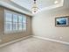 Bedroom with trey ceiling, chandelier, and large window with plantation shutters at 9480 Sw 76Th St, Ocala, FL 34481