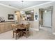 Cozy dining area with a wooden table, chandelier, and a view of the kitchen through a pass-through at 9480 Sw 76Th St, Ocala, FL 34481