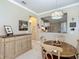 Dining area with a wooden table, buffet cabinet, and view of the kitchen at 9480 Sw 76Th St, Ocala, FL 34481