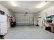 Spacious garage with epoxy floors, overhead storage, and ample space for parking and storage solutions at 9480 Sw 76Th St, Ocala, FL 34481