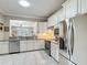 Kitchen features stainless steel appliances and white cabinets with ample counter space at 9480 Sw 76Th St, Ocala, FL 34481