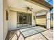 Covered patio with brick flooring, ceiling fan, and sliding glass doors creating a comfortable outdoor space at 9480 Sw 76Th St, Ocala, FL 34481