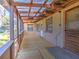 View of the screened-in back porch with wooden floors and exposed rafters at 1022 Ne 11Th Ave, Ocala, FL 34470