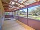 Spacious back porch with wooden floor and view of backyard at 1022 Ne 11Th Ave, Ocala, FL 34470