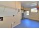 Unfinished basement area with utility access and blue painted floor at 1022 Ne 11Th Ave, Ocala, FL 34470