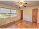 A bright bedroom with hardwood floors and a ceiling fan at 1022 Ne 11Th Ave, Ocala, FL 34470