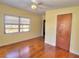 Bedroom with hardwood floors, a ceiling fan, and window at 1022 Ne 11Th Ave, Ocala, FL 34470