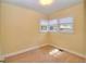 Sunlit bedroom with wall-to-wall carpet and three windows at 1022 Ne 11Th Ave, Ocala, FL 34470