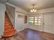 Inviting entryway with wood-look floors, staircase, and natural light from the window at 1022 Ne 11Th Ave, Ocala, FL 34470