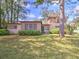 Charming home with a well-manicured lawn and mature trees providing shade at 1022 Ne 11Th Ave, Ocala, FL 34470