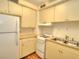 Bright kitchen features white appliances, light cabinets, and hardwood flooring at 1022 Ne 11Th Ave, Ocala, FL 34470