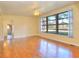 Sun-filled living room featuring hardwood floors and a large window showcasing outdoor views at 1022 Ne 11Th Ave, Ocala, FL 34470