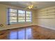 Bright living room with hardwood floors, large windows, and built-in shelving at 1022 Ne 11Th Ave, Ocala, FL 34470