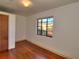 Laminate floored bedroom featuring a window with a view and a neutral color scheme at 1034 Ne 11Th St, Ocala, FL 34470