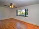 Bright bedroom with hardwood floors, a ceiling fan, and a large window at 1034 Ne 11Th St, Ocala, FL 34470