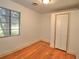 Bright bedroom with laminate floors, a large window and a closet at 1034 Ne 11Th St, Ocala, FL 34470