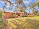 Charming single-story home with mature landscaping and a walkway to the front door at 1034 Ne 11Th St, Ocala, FL 34470