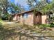 Well-maintained single-story home with a neutral paint scheme and lush landscaping at 1034 Ne 11Th St, Ocala, FL 34470