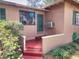 The front porch shows a painted red floor and a dark-green door at 1034 Ne 11Th St, Ocala, FL 34470